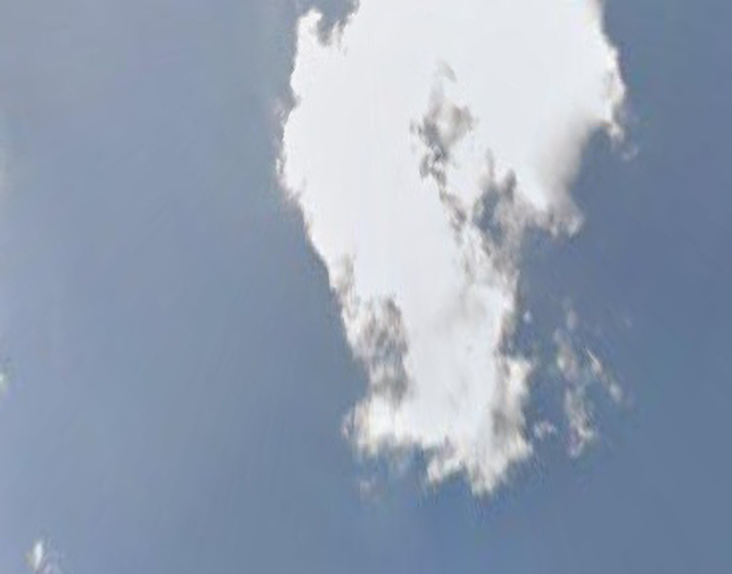 An abstract photograph of clouds against a blue sky.