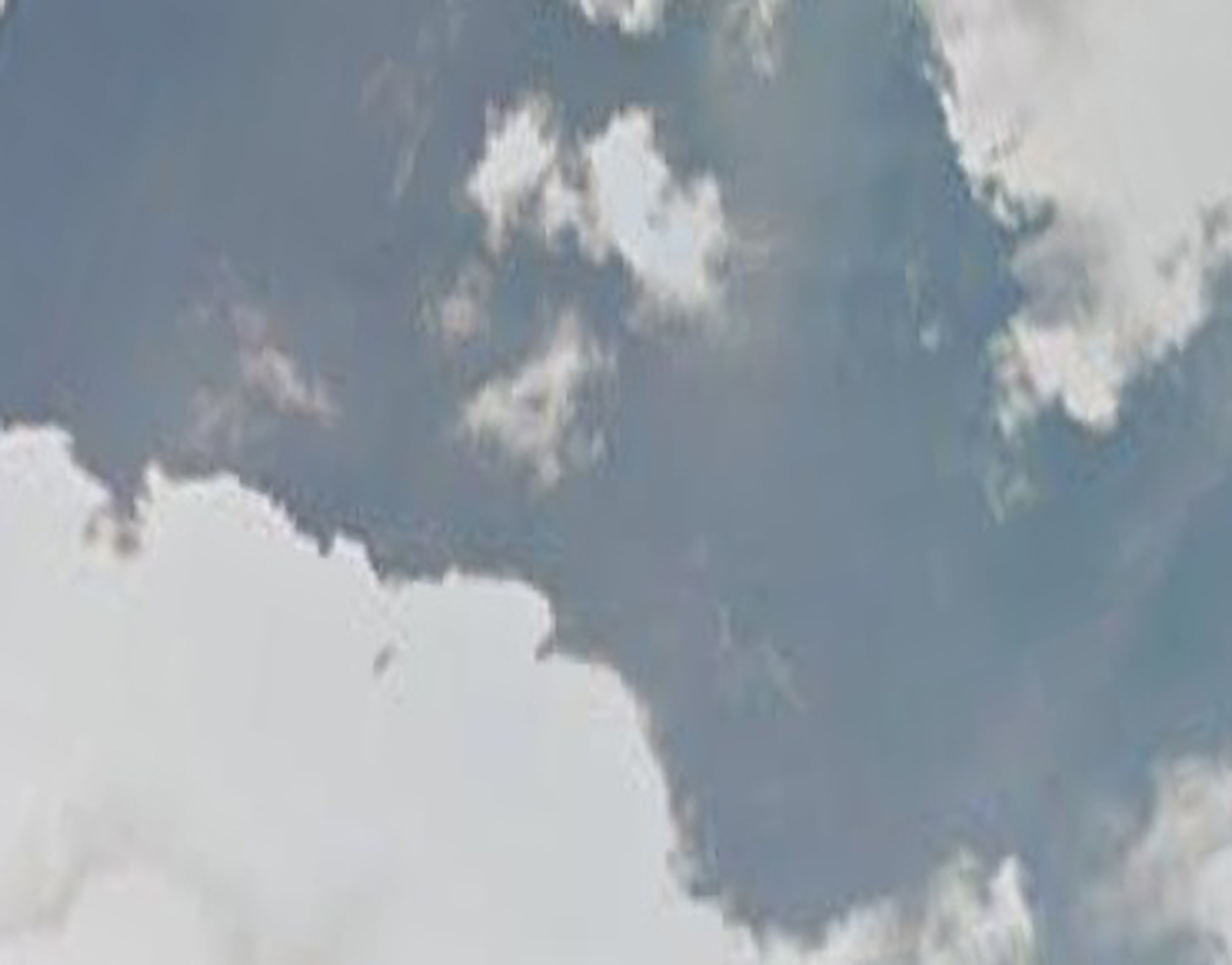 An abstract photograph of clouds against a blue sky.