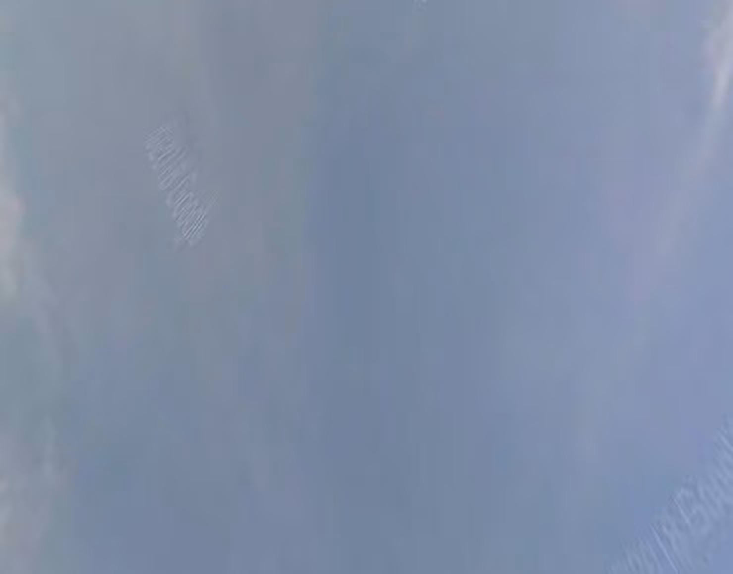 An abstract photograph of clouds against a blue sky.