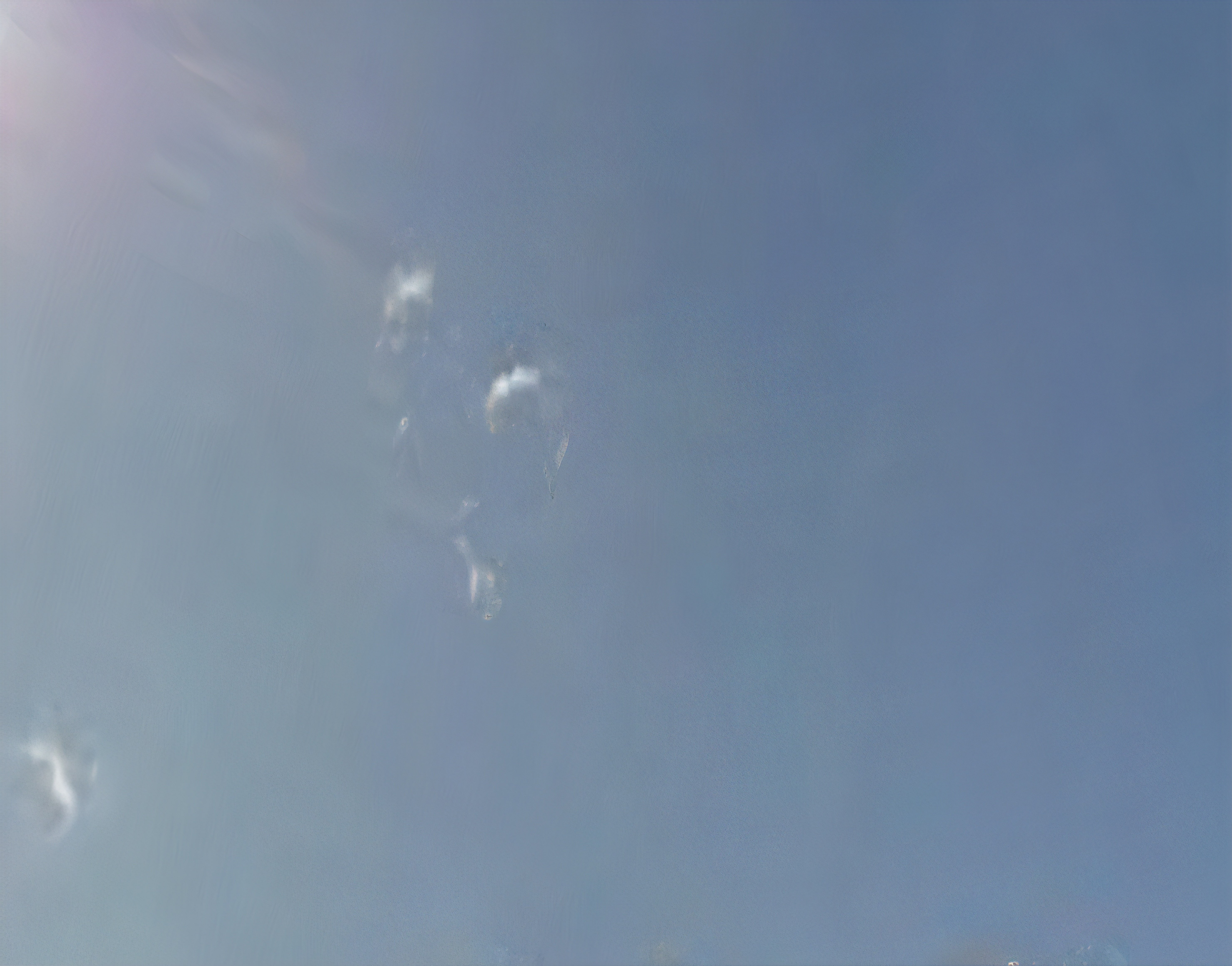 An abstract photograph of clouds against a blue sky.