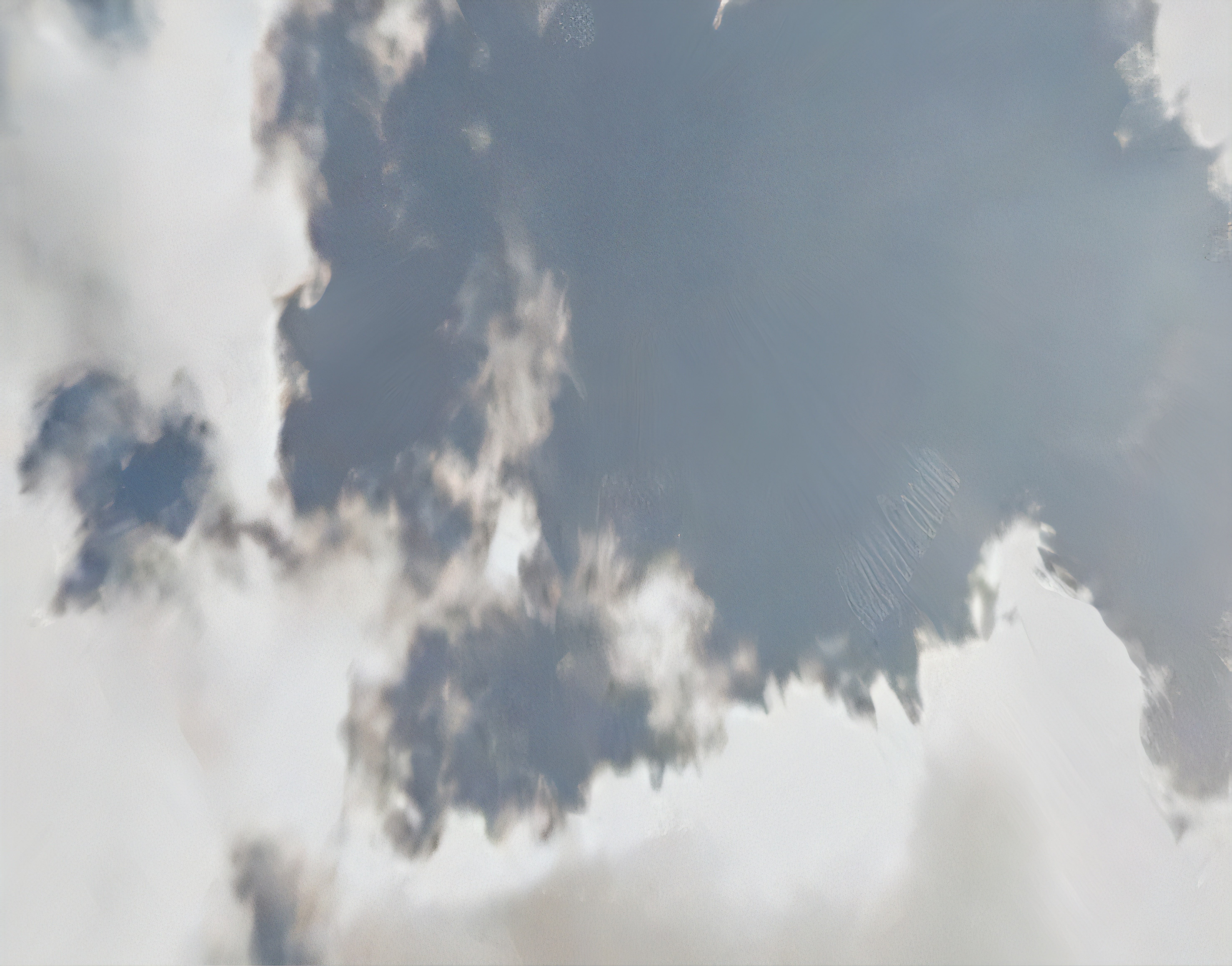 An abstract photograph of clouds against a blue sky.